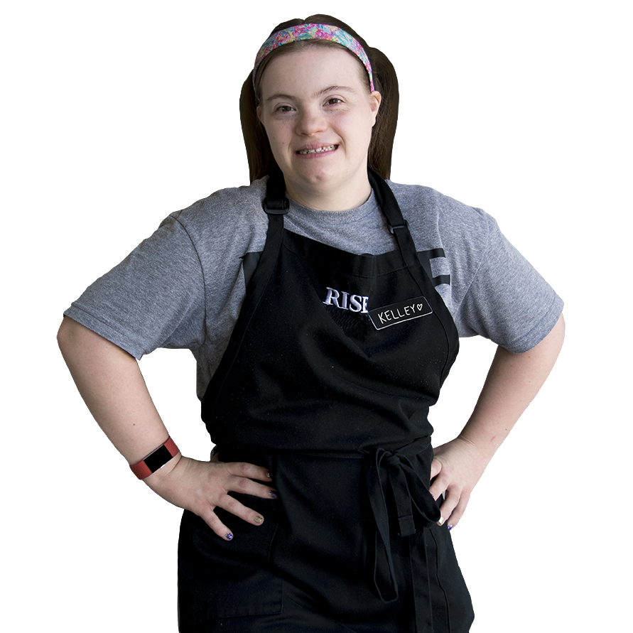 A woman with Down syndrome working at Rise Up Cafe, supported by Inclusion Revolution